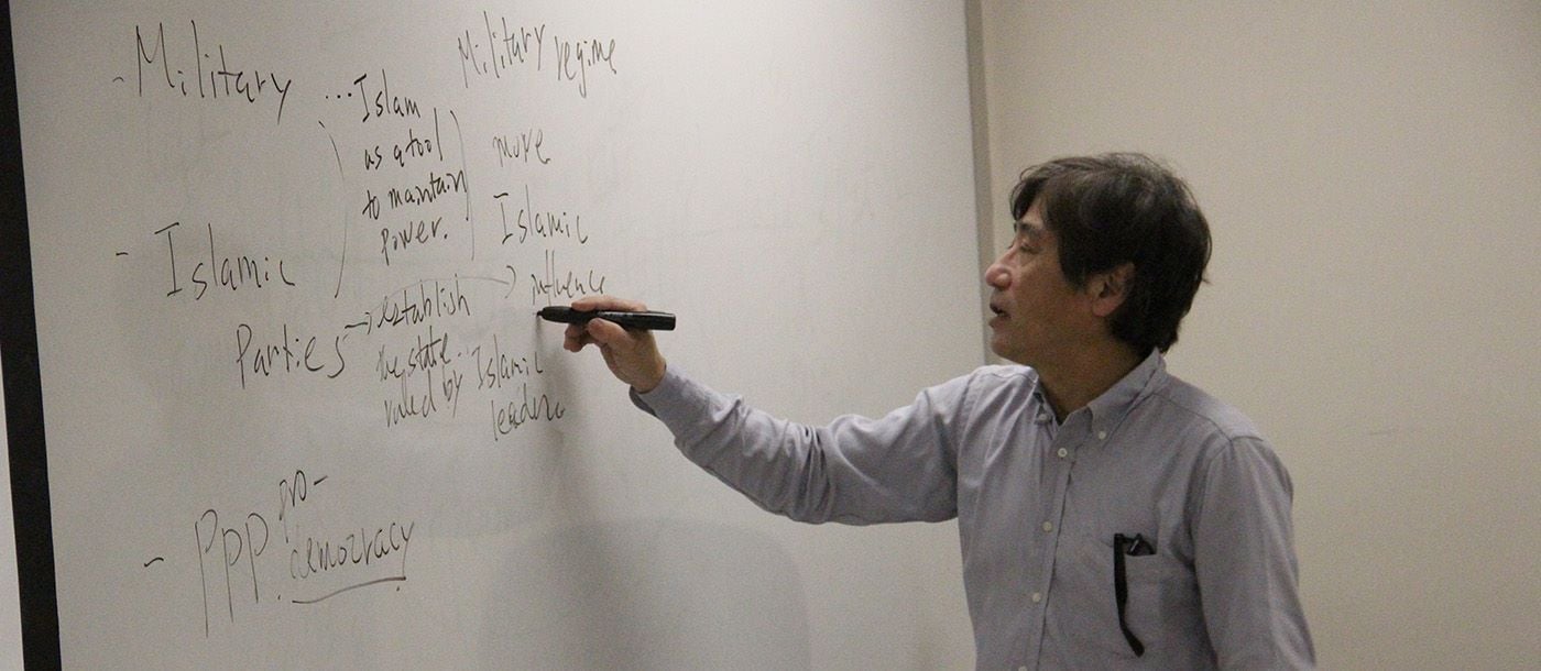 Professor writing on the white board