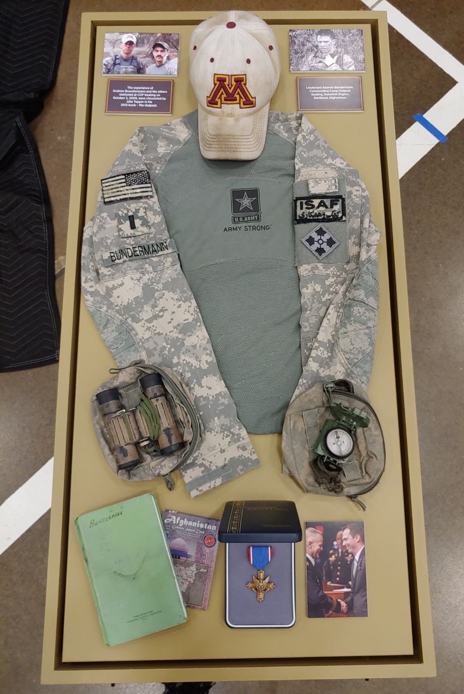 Uniform and photos in a case on display at the Resolute: MN Stories of 9/11 and The War Traveling Exhibit