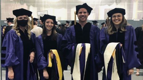four school of psychology spring 2022 graduates posing for a photo