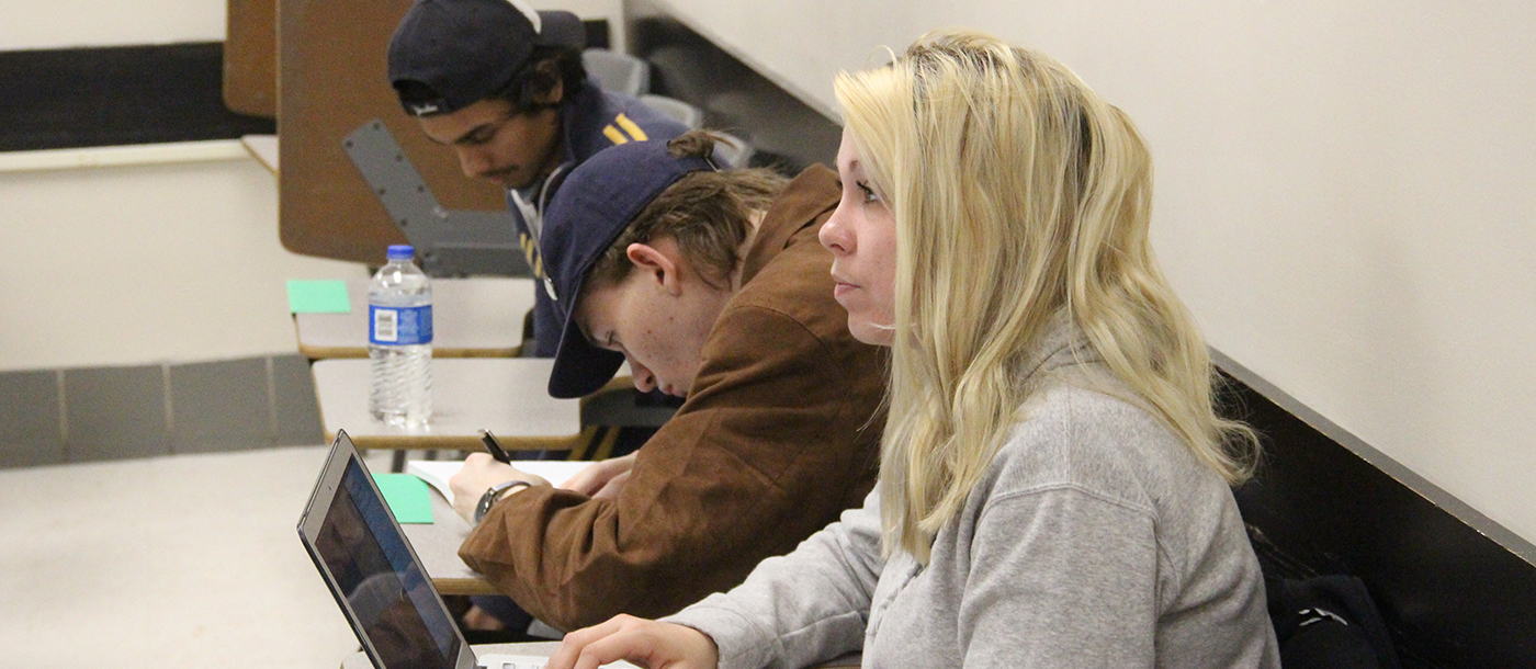 Three students in class session